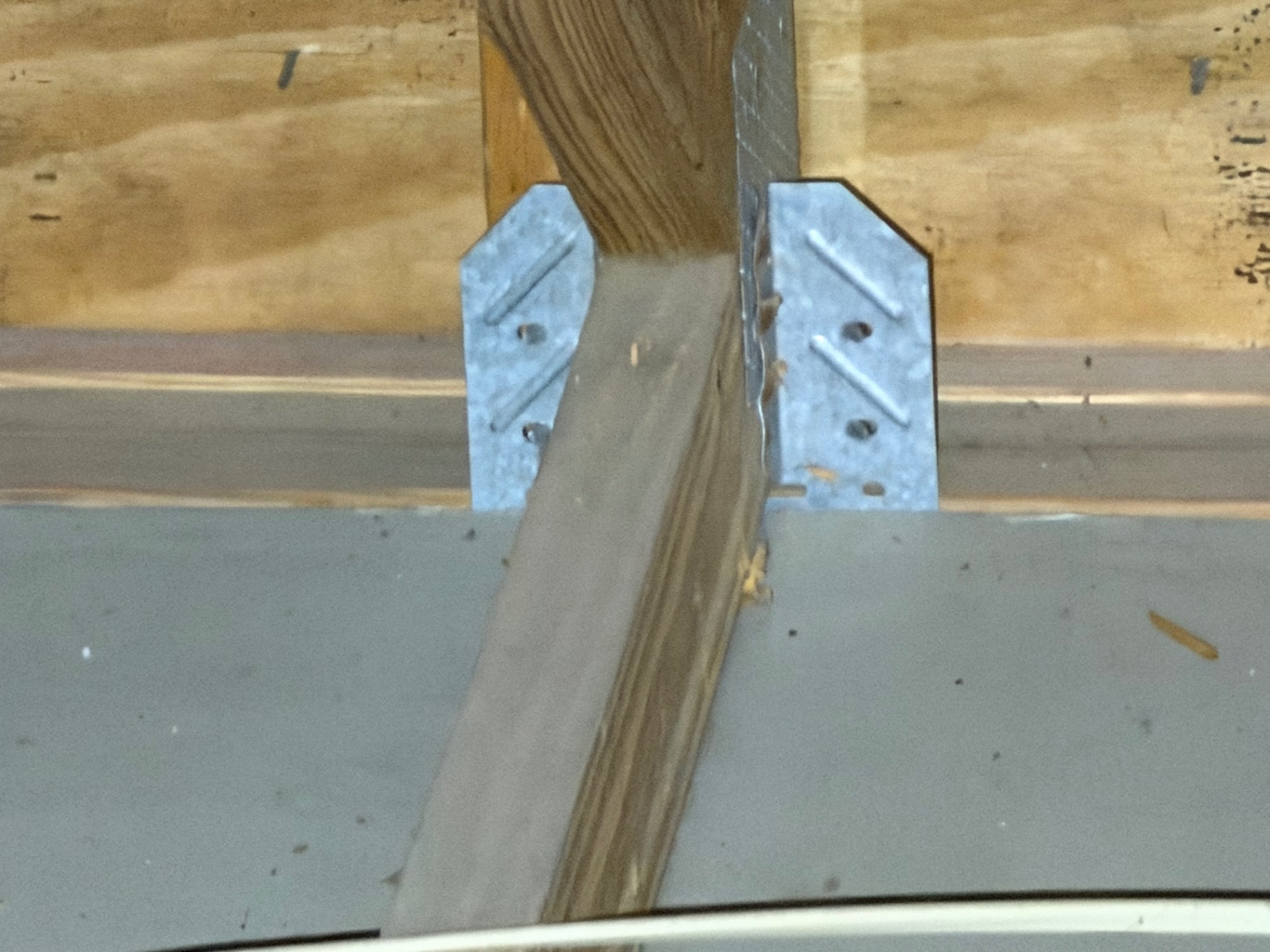 Hurricane clip securing truss to top plate